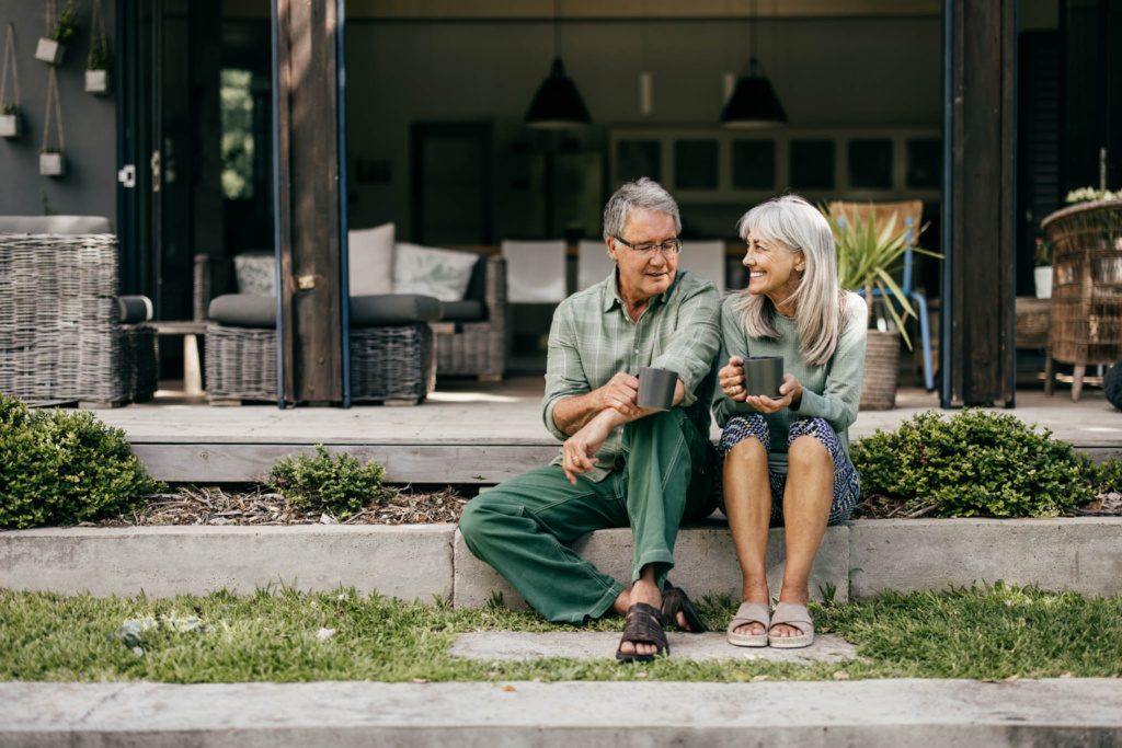 grey-haired-couple-enjoying-coffee-outdoors